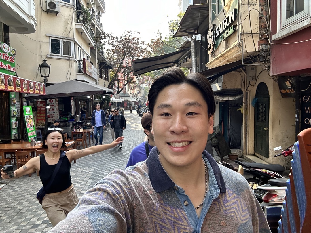 Simon smiling on a street trip with friends.